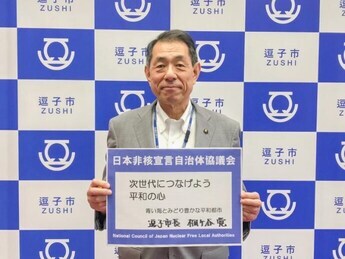 写真：メッセージを持つ桐ケ谷市長